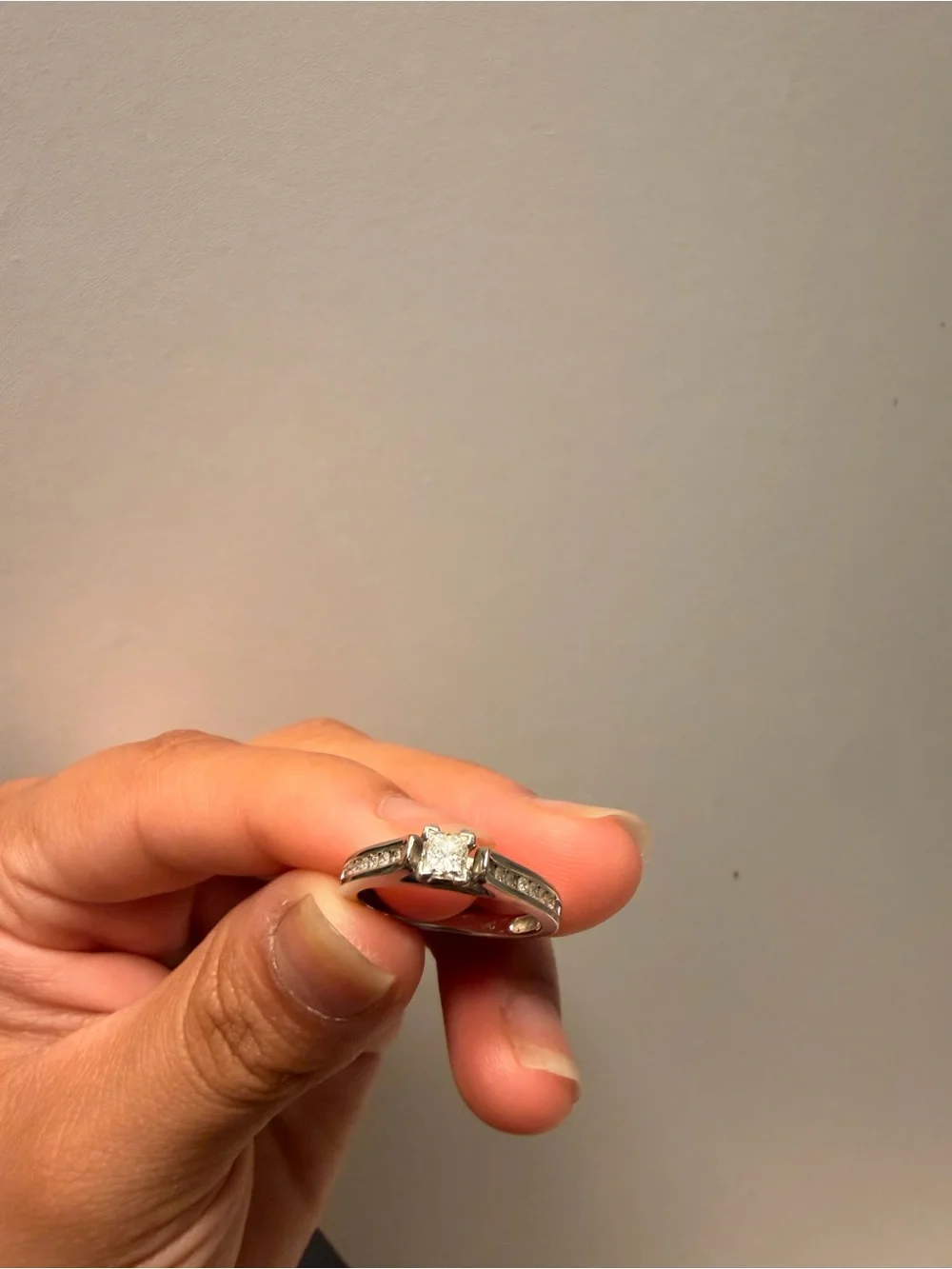 14k white gold with a 1 carat diamond princess cut ring.